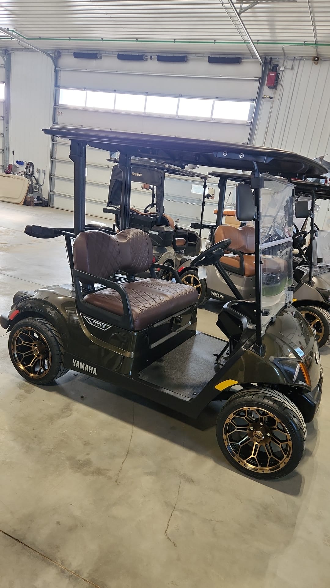Olive bronze Yamaha Drive2 with burgundy diamond-stitched seats in the shop