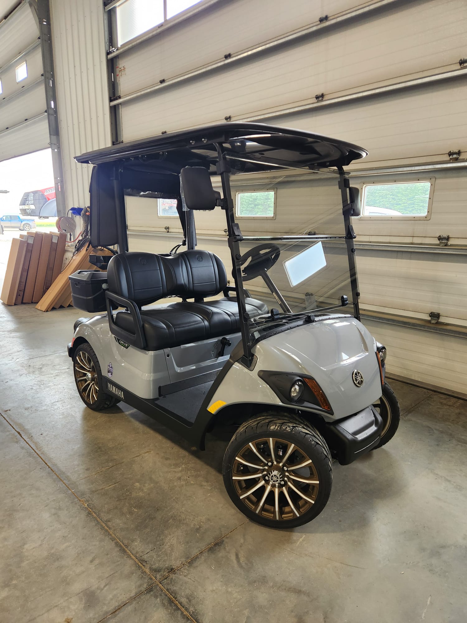 Grey 2027 Yamaha Drive2 with black seats and bronze wheels in the shop