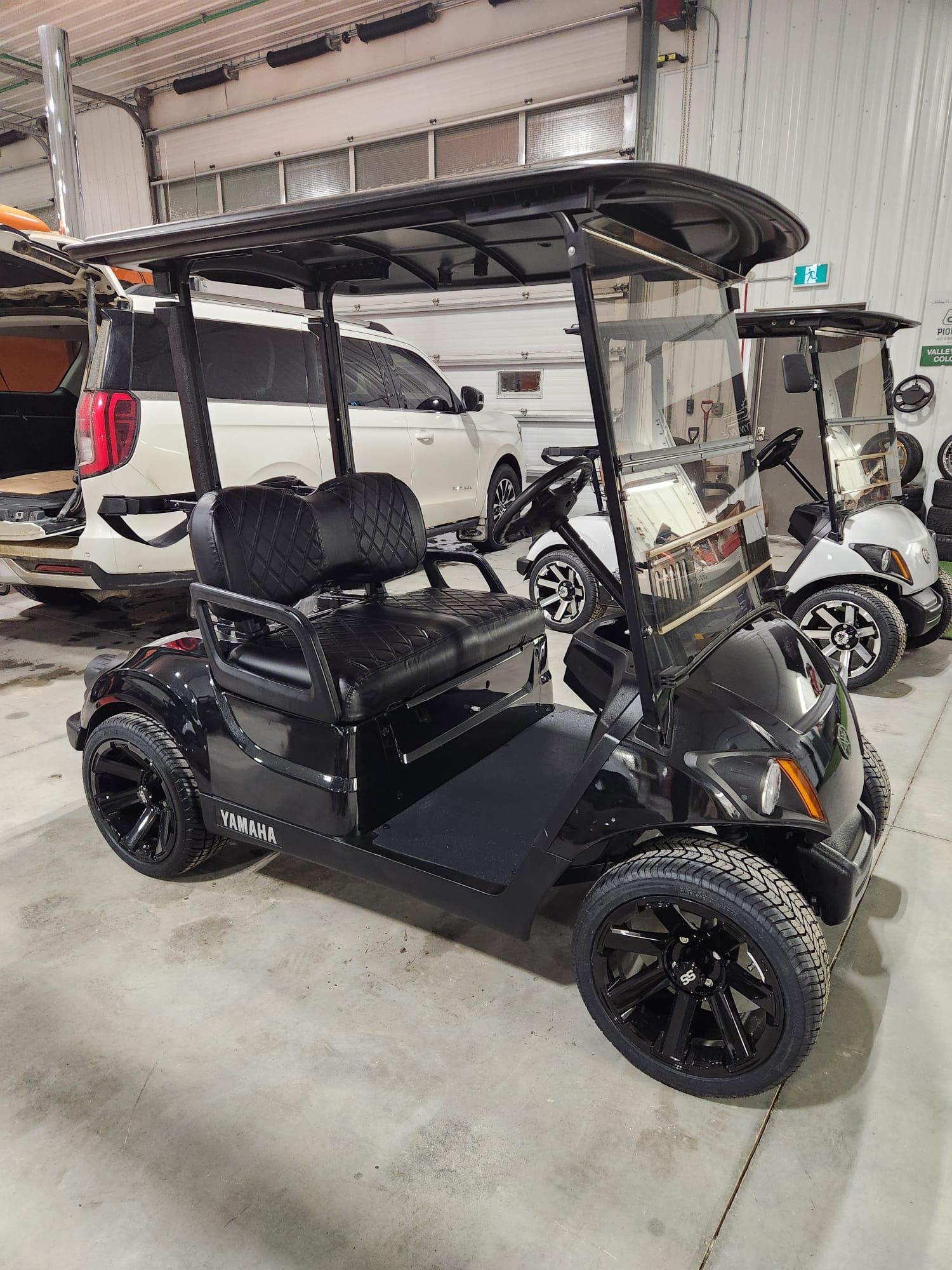Gloss black Yamaha Drive2 with black diamond-stitched seats and black wheels