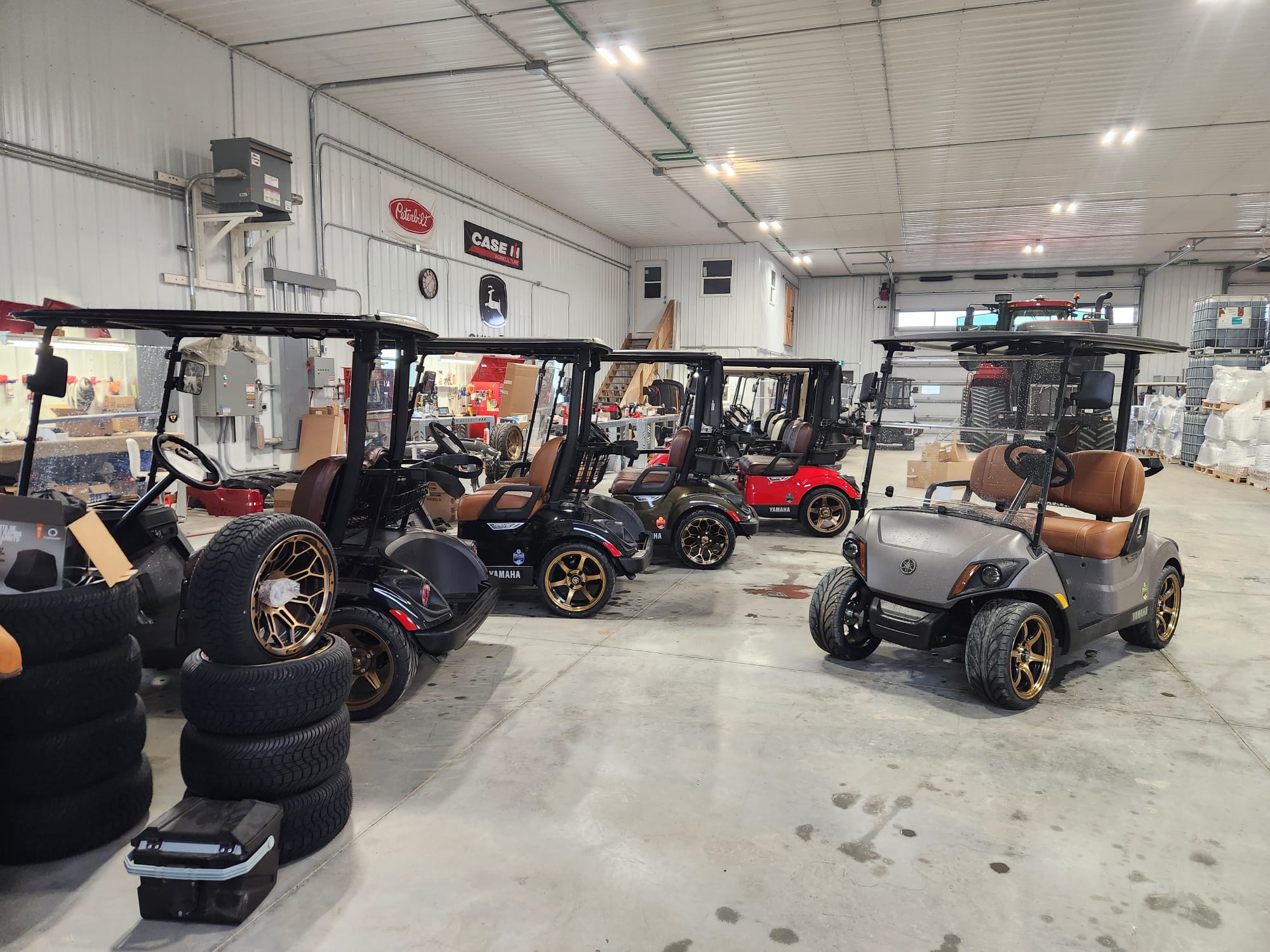 Row of custom Yamaha carts inside the Road Fiftynine shop
