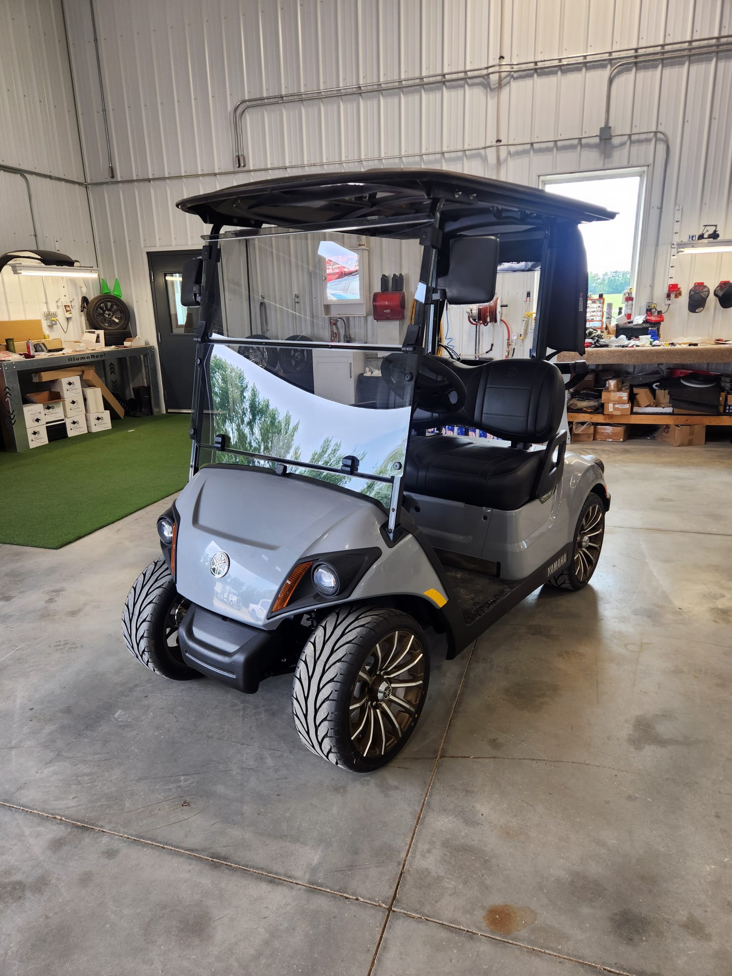 Grey Yamaha Drive2 with black seats and machined wheels in the shop