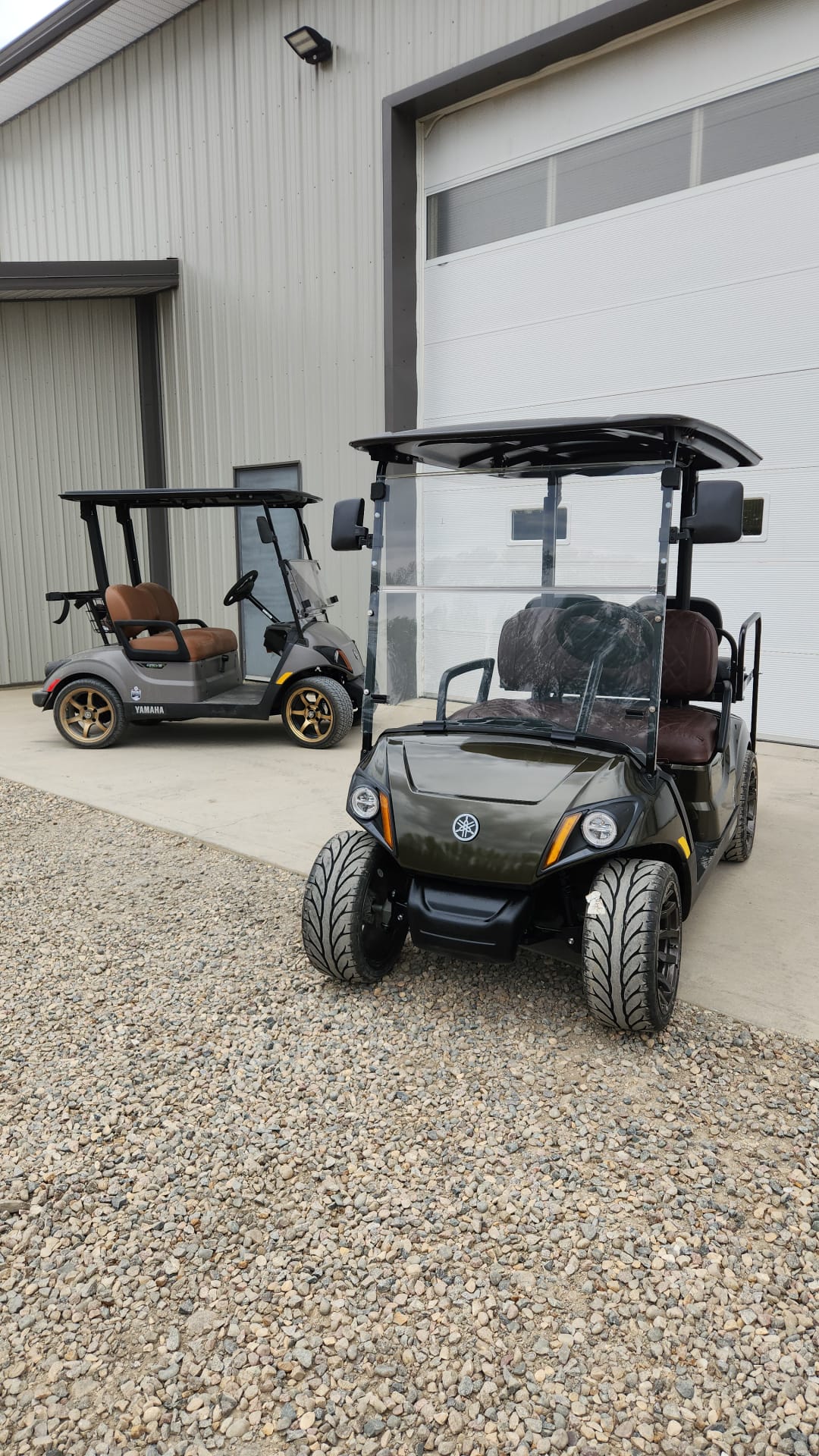 Olive green four-seater Yamaha cart outside the shop