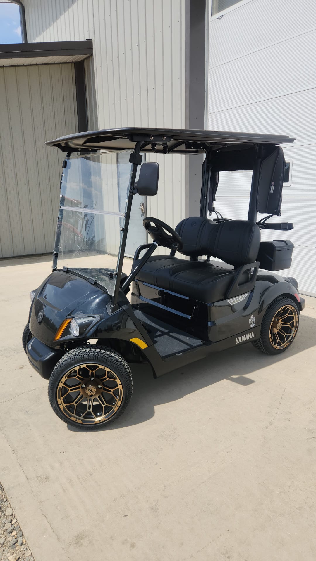 Black Yamaha cart with bronze wheels and mirrors